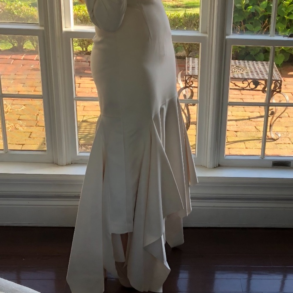 Cream colored, modest layered dress.